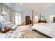 Bright main bedroom with a sitting area, French doors, hardwood floors and neutral color palette at 492 Conway Manor Nw Dr, Atlanta, GA 30327