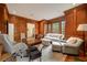 Spacious office featuring wood paneling, built-in cabinets, comfortable seating, and natural light at 492 Conway Manor Nw Dr, Atlanta, GA 30327