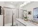 Bathroom with double sink vanity, granite countertops, and glass enclosed shower at 1095 Tucker Ave # 207, Atlanta, GA 30310