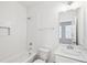 Bright white bathroom featuring subway tile, soaking tub, and single vanity with marble countertop at 1095 Tucker Ave # 207, Atlanta, GA 30310
