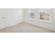 Bedroom features plush neutral carpet, white walls and trim, and large windows with tree views at 1095 Tucker Ave # 207, Atlanta, GA 30310
