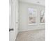 Bright bedroom features neutral carpet, white walls and trim, and sun-filled windows with wooded views at 1095 Tucker Ave # 207, Atlanta, GA 30310