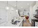 Bright kitchen with white cabinets and a large island with seating, open to the living room at 1095 Tucker Ave # 207, Atlanta, GA 30310