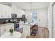 Modern kitchen with white cabinets, stainless steel appliances, and a stylish backsplash at 1095 Tucker Ave # 207, Atlanta, GA 30310