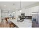 Open-concept eat-in kitchen flowing into the living area with stainless appliances and center island at 1095 Tucker Ave # 207, Atlanta, GA 30310