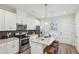 Bright kitchen with stainless steel appliances, an island with seating, and granite countertops at 1095 Tucker Ave # 207, Atlanta, GA 30310