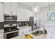 Modern kitchen featuring stainless steel appliances, quartz countertops, and a stylish backsplash at 1095 Tucker Ave # 207, Atlanta, GA 30310