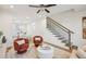 Open-concept living room with hardwood floors and stairway at 1095 Tucker Ave # 207, Atlanta, GA 30310