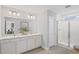 Bright bathroom features a double sink vanity with shower and white subway tile at 126 Kenney Way, Locust Grove, GA 30248