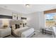 Relaxing bedroom featuring neutral tones, a comfortable bed, and a bright window seat at 126 Kenney Way, Locust Grove, GA 30248