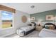 Cozy bedroom features twin beds, complementary decor, and a bright window view at 126 Kenney Way, Locust Grove, GA 30248