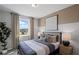 Cozy bedroom with a comfortable bed, neutral decor, and a large window for natural light at 126 Kenney Way, Locust Grove, GA 30248