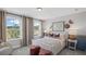 Stylish bedroom featuring soft hues, comfortable bed, and bright windows at 126 Kenney Way, Locust Grove, GA 30248