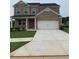 Charming two-story brick home with a manicured lawn and a two-car garage at 126 Kenney Way, Locust Grove, GA 30248
