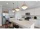 Contemporary kitchen with white cabinetry, an island with bar stools, and modern stainless appliances at 126 Kenney Way, Locust Grove, GA 30248
