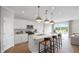 Modern kitchen with white cabinets, quartz countertops, stainless steel appliances, and a breakfast bar at 126 Kenney Way, Locust Grove, GA 30248