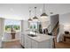 Open kitchen with stainless steel appliances, granite countertops and breakfast bar overlooks the Gathering room at 126 Kenney Way, Locust Grove, GA 30248