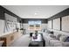 A contemporary living room features stylish seating, decor, and ample natural light at 126 Kenney Way, Locust Grove, GA 30248