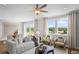Bright living room features comfortable seating, neutral tones, and large windows with backyard views at 126 Kenney Way, Locust Grove, GA 30248