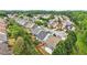 Aerial view showcases the rooflines, landscaping, and community layout, surrounded by trees at 1620 Diplomat Dr, Cumming, GA 30041