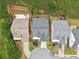 Overhead shot shows backyard, roof and driveway of suburban home in a tree-lined neighborhood at 1620 Diplomat Dr, Cumming, GA 30041