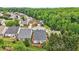 An aerial view of the neighborhood's homes, surrounded by lush greenery and mature trees at 1620 Diplomat Dr, Cumming, GA 30041