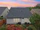 Well-maintained backyard with a patio, a small table with a grill, and colorful flowers at 1620 Diplomat Dr, Cumming, GA 30041