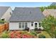 Well-maintained backyard with a patio, a small table with a grill, and colorful flowers at 1620 Diplomat Dr, Cumming, GA 30041