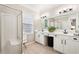 Bright bathroom features a double sink vanity and a glass enclosed walk-in shower at 1620 Diplomat Dr, Cumming, GA 30041