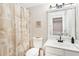 Bright bathroom featuring a toilet, sink and floral shower curtain for a cozy, inviting feel at 1620 Diplomat Dr, Cumming, GA 30041
