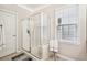 Bright bathroom features a glass enclosed walk-in shower and neutral tones at 1620 Diplomat Dr, Cumming, GA 30041