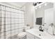 Neutral bathroom features a shower with a white curtain and vanity with a black faucet at 1620 Diplomat Dr, Cumming, GA 30041