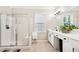 Bright bathroom features a glass enclosed walk-in shower and a double sink vanity at 1620 Diplomat Dr, Cumming, GA 30041