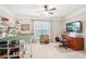 Large bedroom features neutral tones, a ceiling fan and a window with natural light at 1620 Diplomat Dr, Cumming, GA 30041