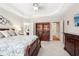 Bedroom featuring tray ceiling, built in bookshelf, and ensuite bathroom at 1620 Diplomat Dr, Cumming, GA 30041