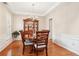 The dining room features hardwood floors, wainscoting, and shuttered windows at 1620 Diplomat Dr, Cumming, GA 30041