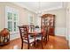 Elegant dining room with hardwood floors, plantation shutters, and a classic china cabinet at 1620 Diplomat Dr, Cumming, GA 30041
