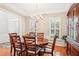 The dining room features hardwood floors, wainscoting, and shuttered windows at 1620 Diplomat Dr, Cumming, GA 30041