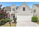 Charming two-story home featuring a two-car garage and manicured front yard at 1620 Diplomat Dr, Cumming, GA 30041