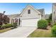 View of an attractive two-story home with a two-car garage and mature landscaping at 1620 Diplomat Dr, Cumming, GA 30041