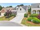 Charming home featuring a manicured lawn, an attached garage, and delightful curb appeal at 1620 Diplomat Dr, Cumming, GA 30041