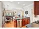 Open kitchen with stainless appliances and a view into the living room and breakfast nook at 1620 Diplomat Dr, Cumming, GA 30041