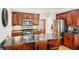 Bright kitchen featuring dark wood cabinets, stainless steel appliances and a large island with sink and counter seating at 1620 Diplomat Dr, Cumming, GA 30041