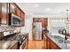 Bright kitchen featuring dark wood cabinets, stainless steel appliances and a large island with sink and counter seating at 1620 Diplomat Dr, Cumming, GA 30041