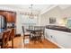 Eat-in kitchen area features a wood table with hardwood floors and natural lighting at 1620 Diplomat Dr, Cumming, GA 30041