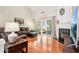 Bright living room features a fireplace, hardwood floors, and sliding glass doors to a screened porch at 1620 Diplomat Dr, Cumming, GA 30041