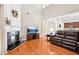 Comfortable living room with a fireplace, hardwood floors, and a view into the kitchen area at 1620 Diplomat Dr, Cumming, GA 30041
