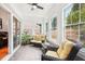 Bright sunroom featuring wicker furniture, large windows, and tiled floor at 1620 Diplomat Dr, Cumming, GA 30041