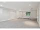 Finished basement area with recessed lights, neutral paint, grey carpet, and window with blind coverings at 2305 Lochinver Sw Ln, Conyers, GA 30094