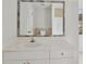 Bathroom vanity features tiled mirror, white cabinets, and a modern faucet at 2305 Lochinver Sw Ln, Conyers, GA 30094